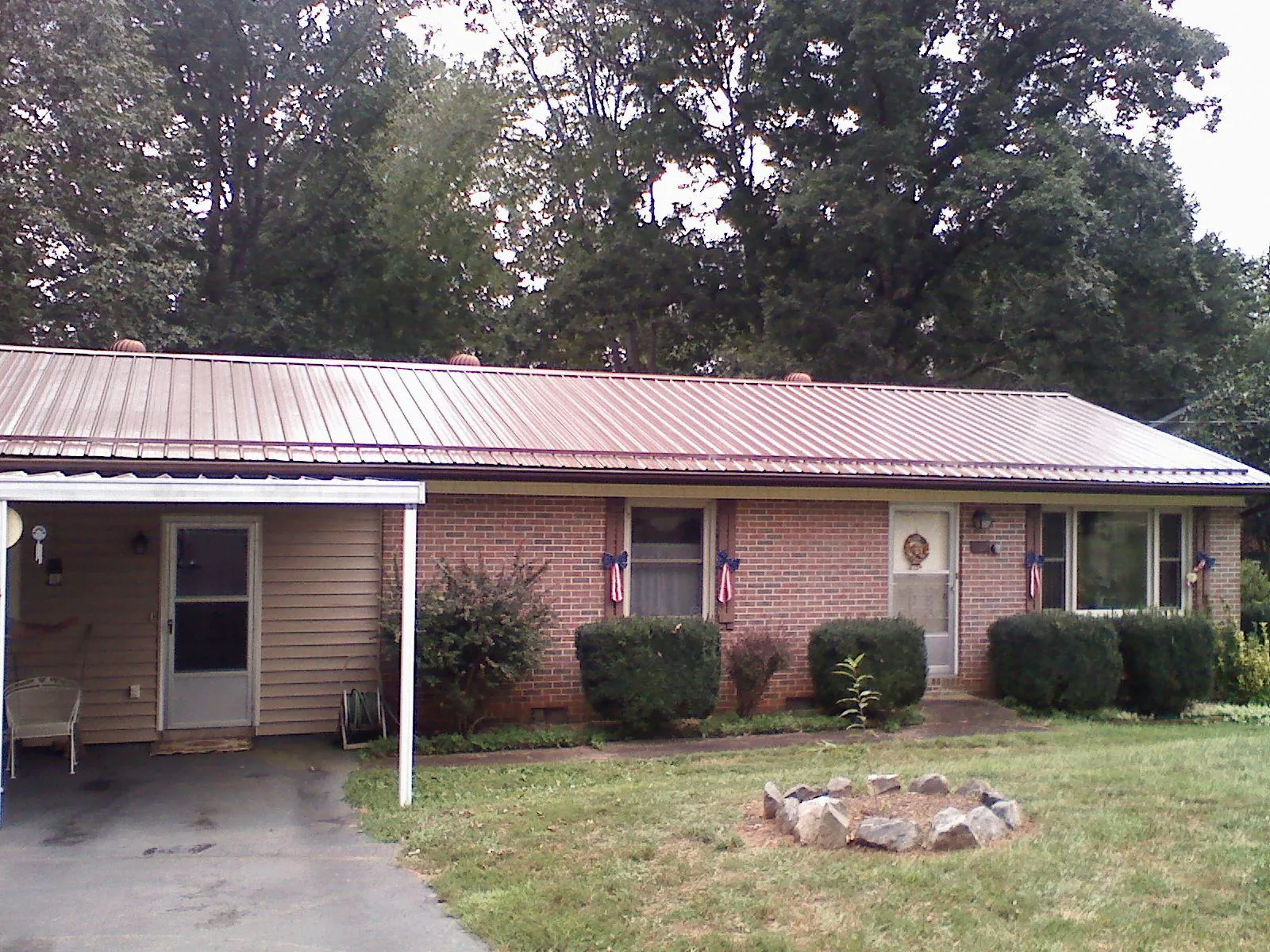 Bronze metal roof and carport on a brick ranch home — Roof Repair work by our crew in East Providence