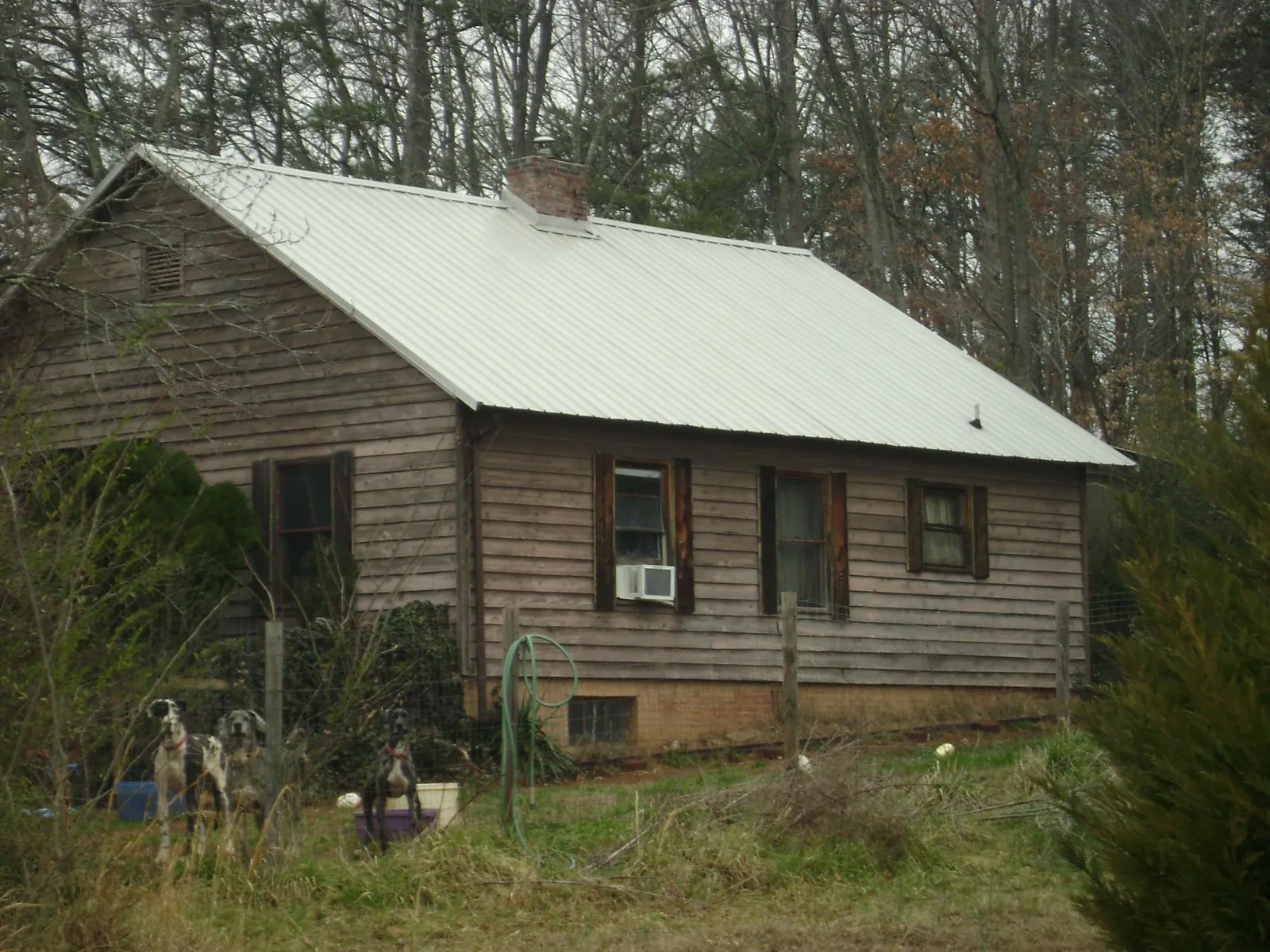 White metal roof on an old wood sided farmhouse, from a Asphalt Shingle Roof Repair job in East Providence