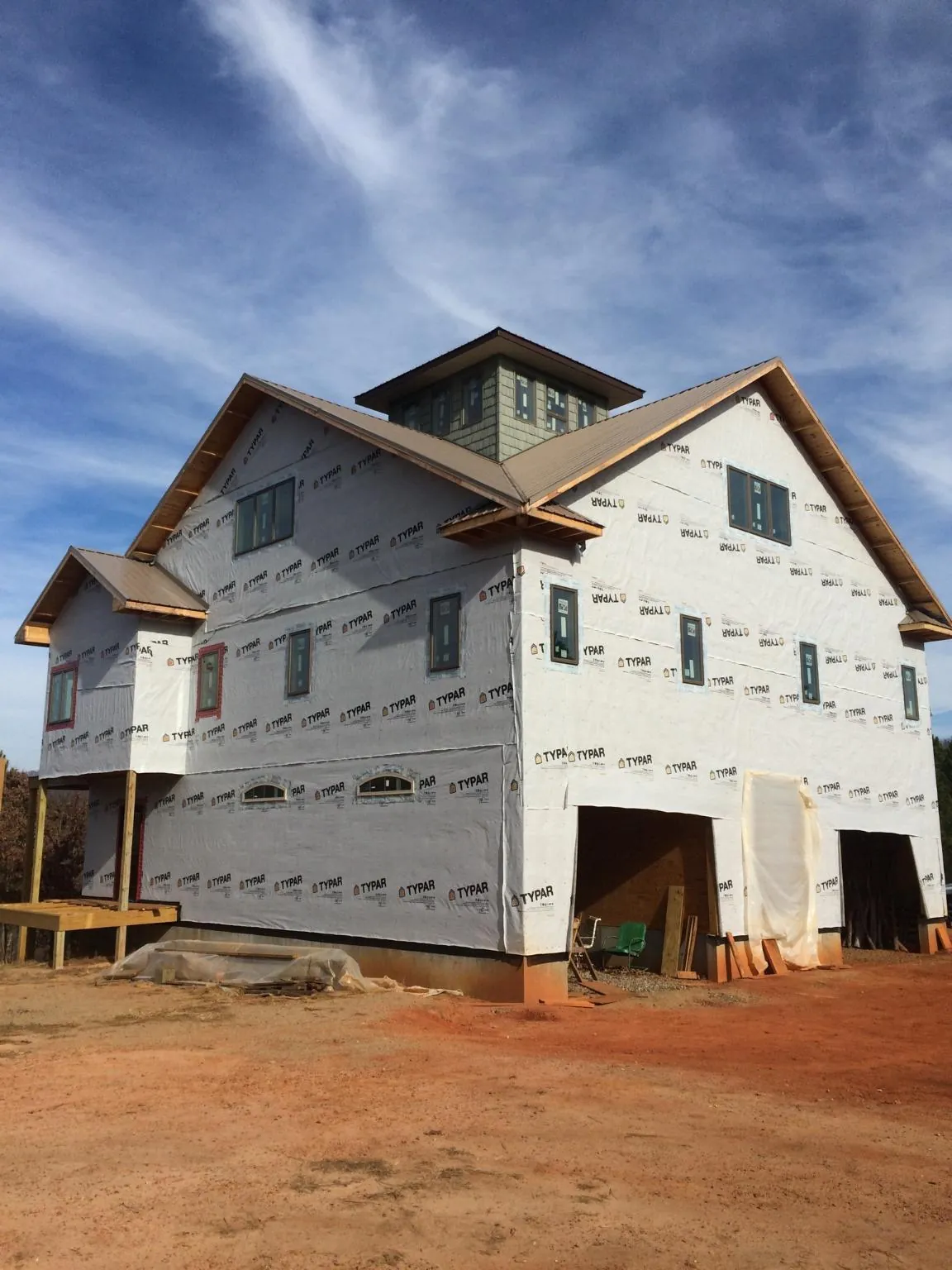 New two story house under construction with a cupola and gabled roofs in East Providence